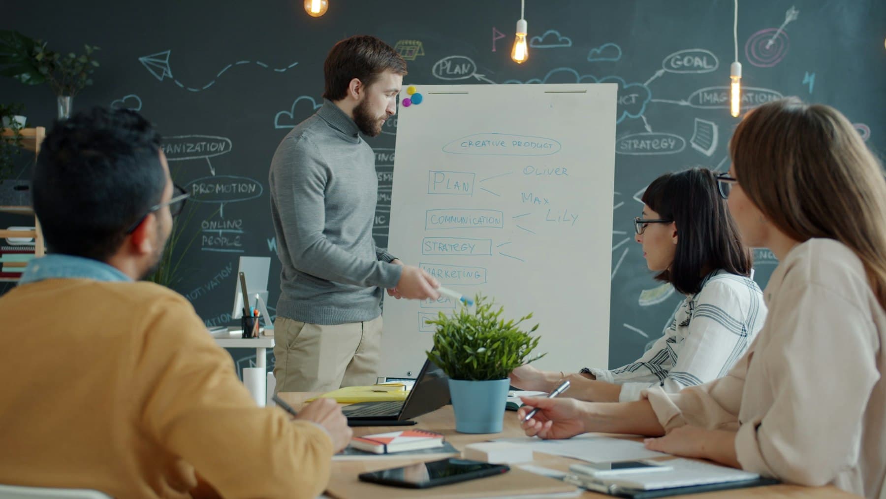 Colleagues planning at a whiteboard in a modern office